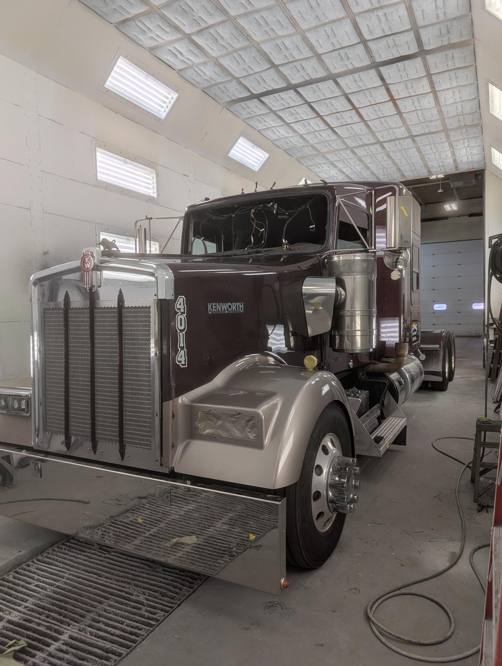 Maroon Kenworth commercial truck after finish work, front three-quarter view