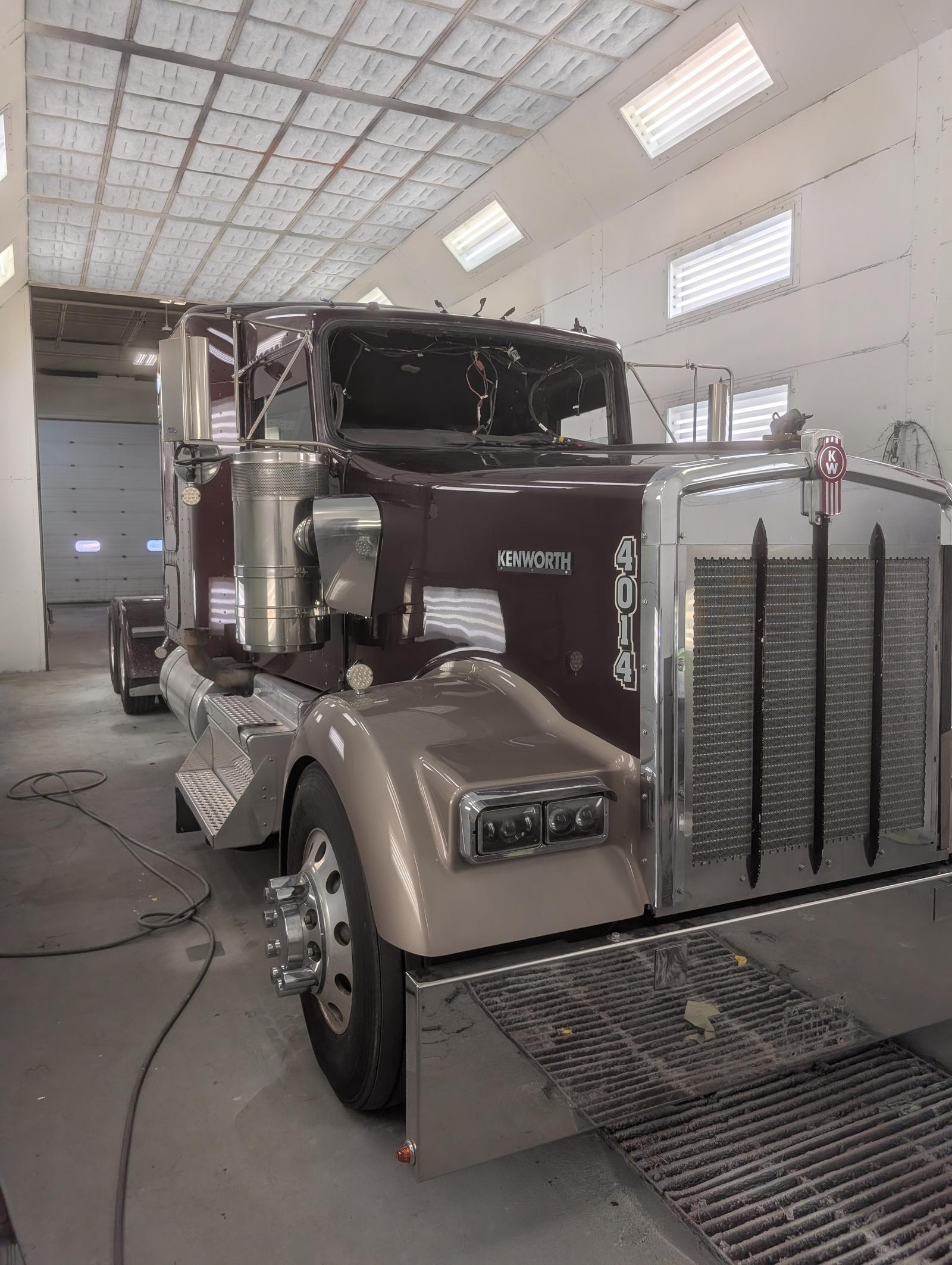 Maroon Kenworth commercial truck after finish work, side view
