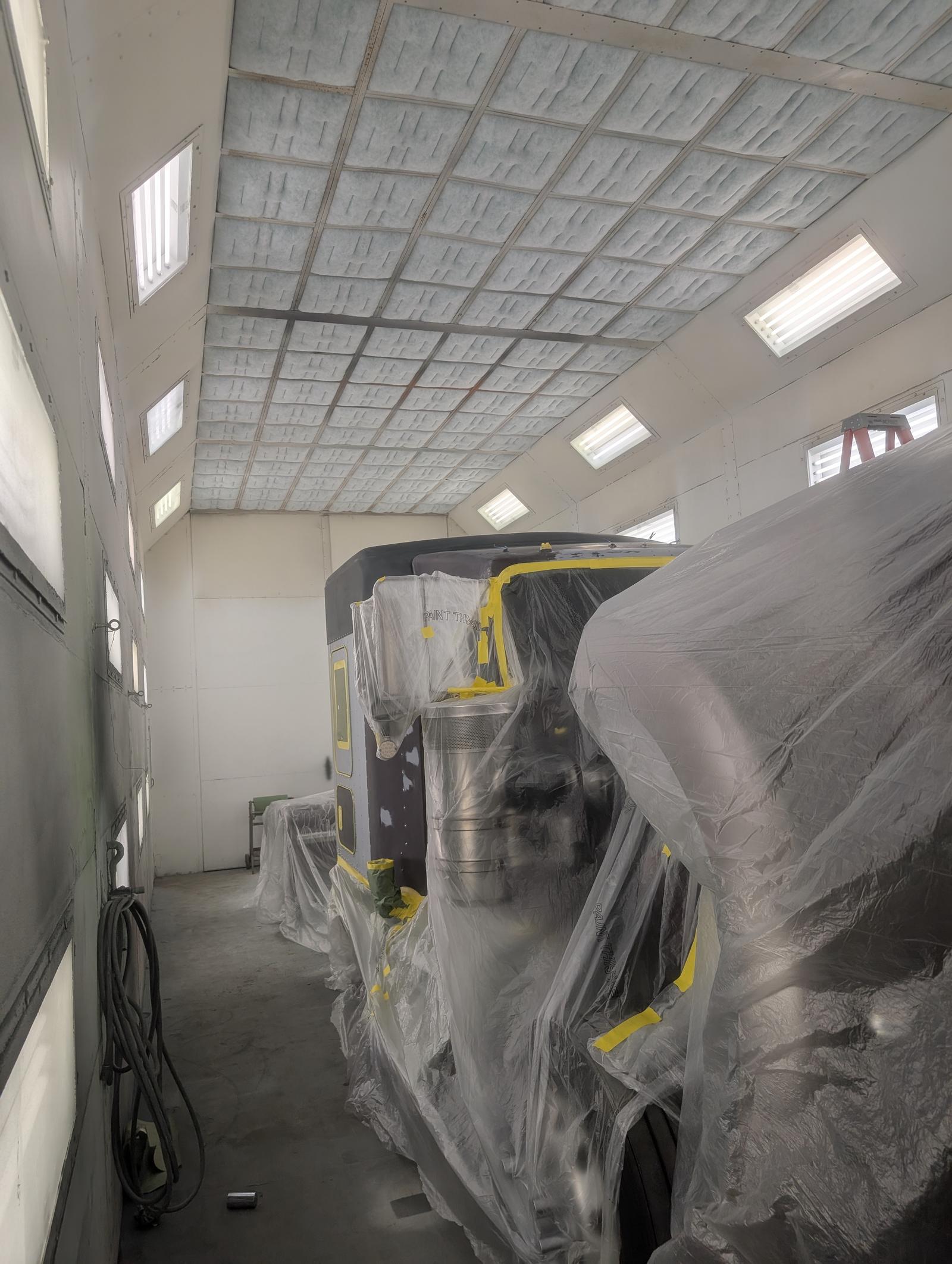 Commercial truck masked and taped in preparation for refinishing